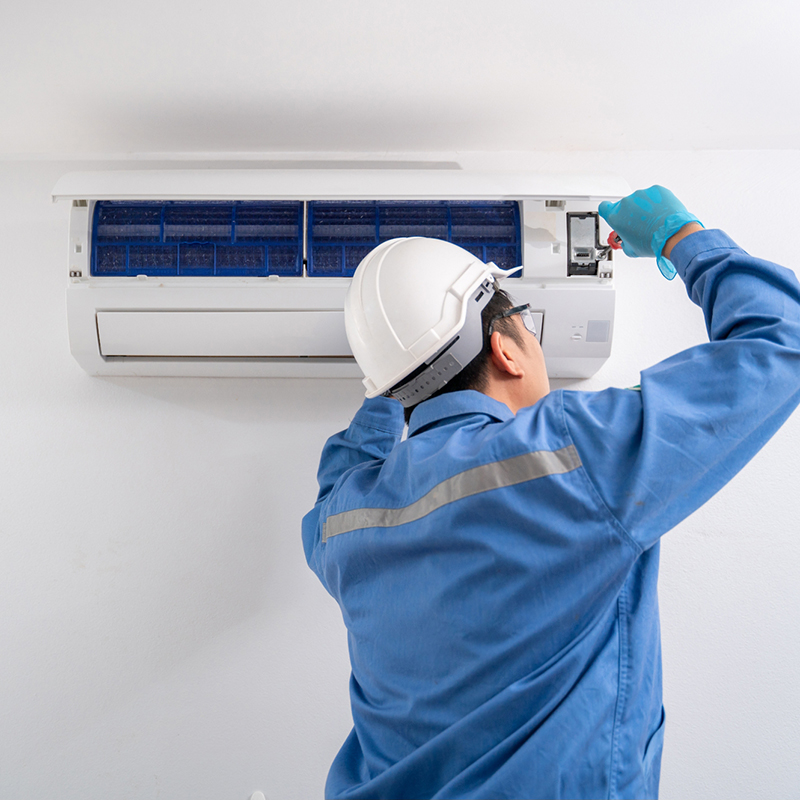 technician carrying out Air Con Maintenance